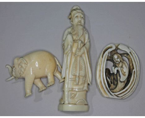 Three pieces of carved ivory comprising a Japanese netsuke, a Chinese deity and an elephant.  