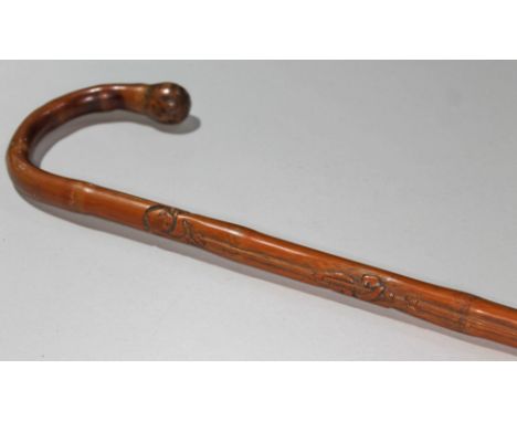 A Chinese cane walking stick carved with monkeys, length 91cm.  