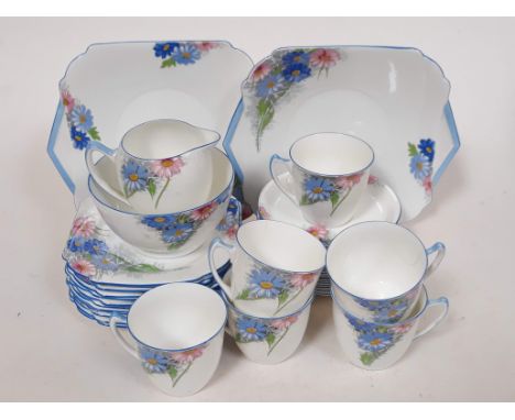 A 32 piece Shelley part tea service number 12216 decorated in blue and pink flowers, comprising two 2 plates, 12 small plates