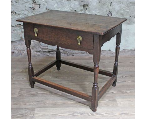 A Georgian oak side table with single drawer, shaped frieze, turned legs and lower rectangular stretchers, width 82cm, depth 