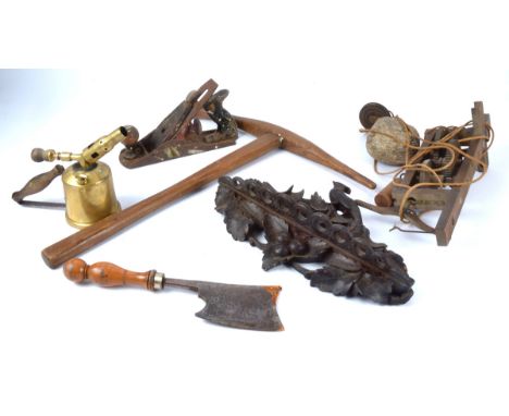 A Black Forest style carved wooden pipe rack&nbsp;of a bird above fruiting vines, 22cm x 37cm, together with a clock movement