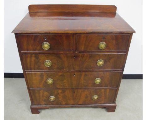 A 19th Century mahogany chest, of two short and three long graduated cock beaded drawers, figural mahogany top with gallery a