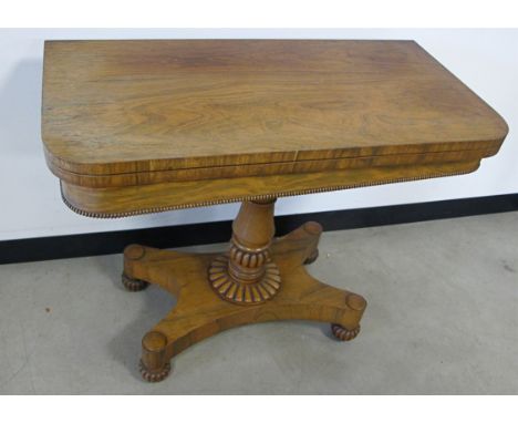 A William IV rosewood folding card table, the folding top opens to reveal green felted top, on turned support with  X shaped 