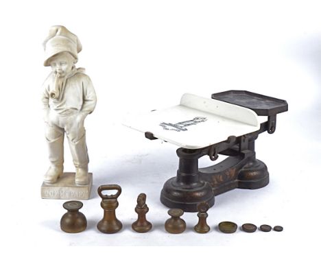 A marble figure of a boy smoking a pipe titled 'Comme Papa', height 36cm, together with a set of shop scales, the ceramic pan