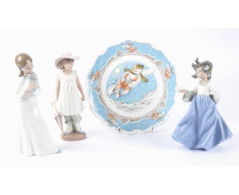 Three Spanish Nao porcelain figures of young ladies,  one a girl with a dove, another a girl with a puppy and another a girl 