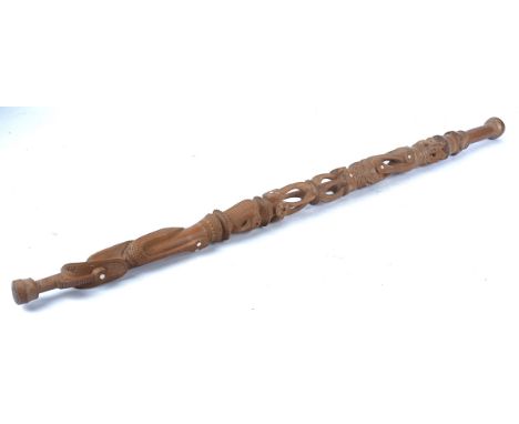 A Massim walking stick of the Trobriand Islands Papua New Guinea, and an Ivory Coast Senufo mask walking stick measuring 102c