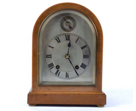 A early 20th Century bracket clock, silvered dial with Roman numerals, subsidiary dial above, 8 day movement, within an arche