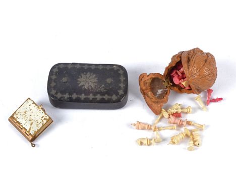 A thirty two piece miniature bone chess set contained within a hollowed walnut,  together with a snuff box and miniature nove