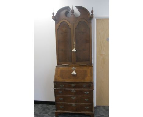 A continental style contemporary walnut bureau bookcase the top section having two panel doors opening to reveal two adjustab