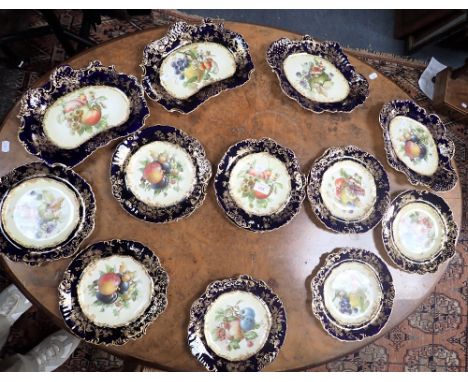 AN EDWARDIAN HAMMERSLEY &amp; CO. DESSERT SERVICE, decorated with fruit within blue and gilt borders