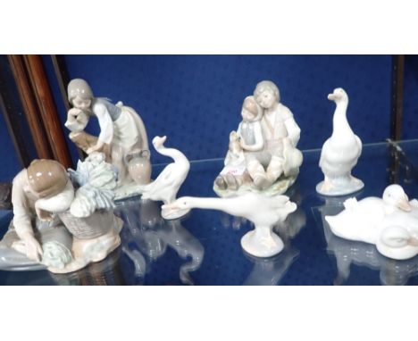 A COLLECTION OF LLADRO AND NAO FIGURINES