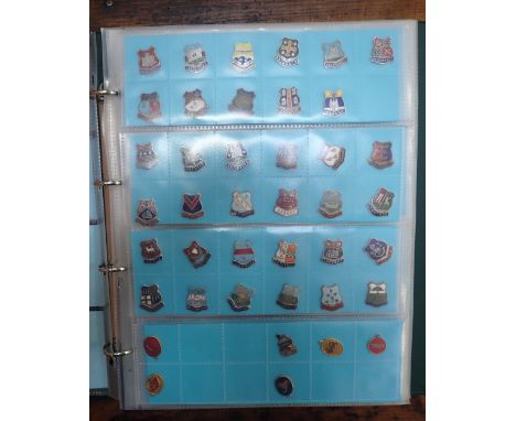 A COLLECTION OF ENAMEL BADGES, PENDANTS, MEDALLIONS etc contained in an album
