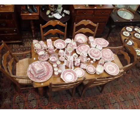 A CONTINENTAL DINING TABLE, 148cm long on turned legs, with a set of six rush seated ladder back chairs, to include two carve