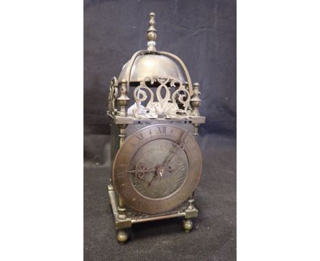 A MAPPIN AND WEBB BRASS LANTERN CLOCK with pierced fret dolphin surmounts enclosing a bell top (on view at Fine Art)