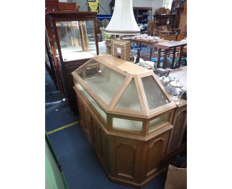 A LIGHT OAK SHOP DISPLAY CABINET in the Gothic style, 148cm wide