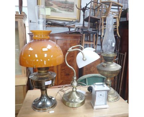 AN EDWARDIAN BRASS OIL LAMP, another, a students lamp and a carriage clock