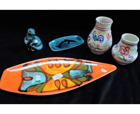 POOLE POTTERY; AN ORANGE DEPHIS DISH, two traditional vases, a dolphin dish and a study of an otter (5)