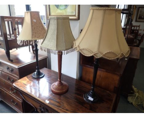 A PAIR OF TABLE LAMPS and a similar red and gilt table lamp (3) (on view at Fine Art)