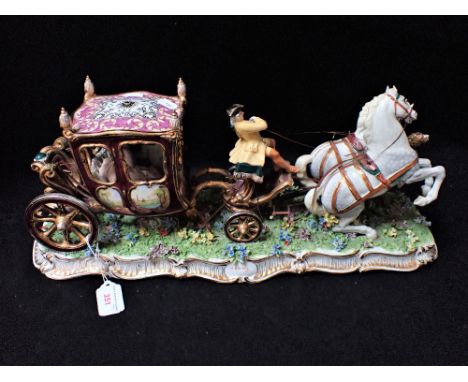 A LARGE ITALIAN CERAMIC STUDY OF A COACH with two white horses, 53cm long