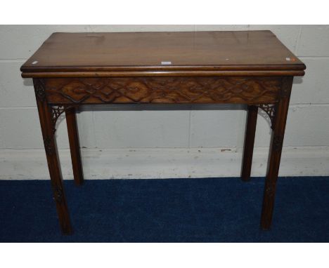 A GEORGE III MAHOGANY FOLD OVER CARD TABLE, green baize interior above a frieze and front legs with fretwork decoration, widt