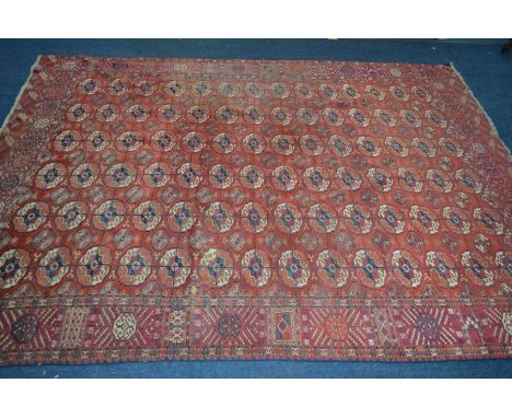 A LATE 19TH/EARLY 20TH CENTURY TEKKE TURKMAN RED GROUND RUG, 280cm x 207cm (low pile in places but overall condition good)Con