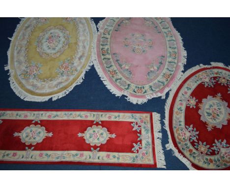 A COLLECTION OF G H FIRTH FOUR WOOLLEN RUGS to include two large oval in pink and yellow, 250cm x 160cm, a smaller oval red r