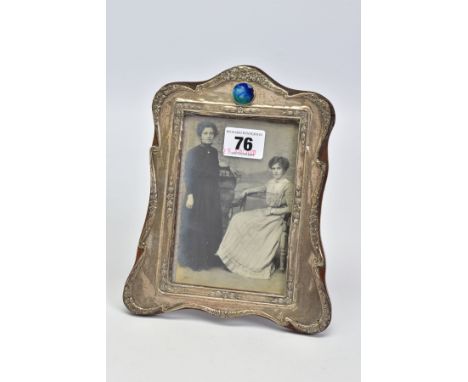 AN EARLY 20TH CENTURY SILVER FRONTED PHOTO FRAME, with embossed floral and foliate detail and a circular blue, green and whit