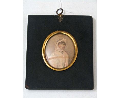 An early 19th century portrait miniature of oval form, waist length study of a woman in a bonnet and lace shawl, 7cm max in b