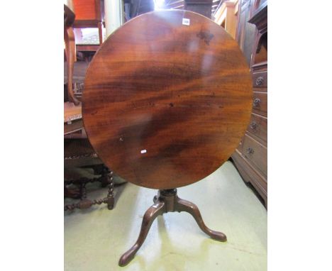 A Georgian mahogany snap top occasional table of circular form, the one piece top 85 cm diameter approx, raised on a turned v