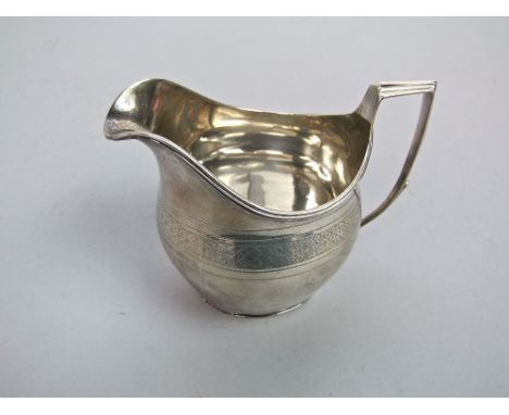 A Georgian silver cream jug with engine turned decoration, London 1809, probably Thomas Barber, 5 oz