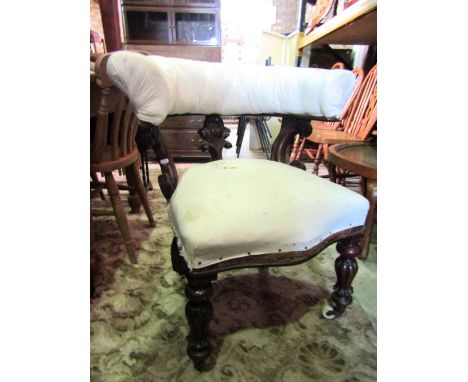 A Victorian library/desk chair with simply upholstered serpentine seat and horseshoe shaped back rail with C scrolled support