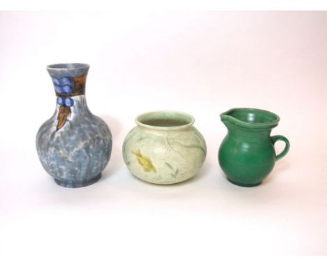 An early 20th century Cranston pottery vase with moulded and painted stylised fruiting vine decoration on a mottled grey grou