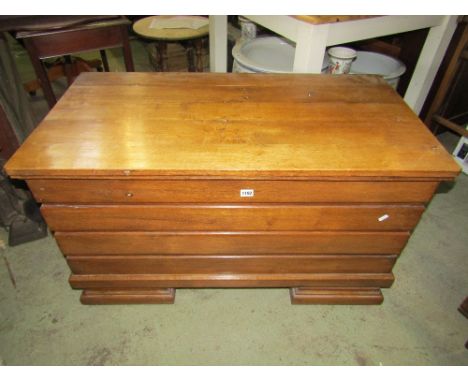 An oak coffer with ribbed framework raised on shaped bracket supports, 105cm wide