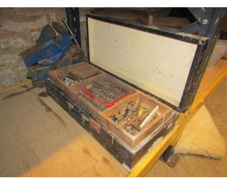 A tool chest containing drill bits, hand tools together with two record vices