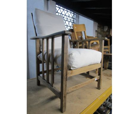 A stripped oak vintage bed chair, with adjustable frame, upholstered seat and back