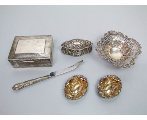 Three embossed silver sweet meat dishes, a shaped trinket box and cover, silver cigarette box and a silver handled grapefruit