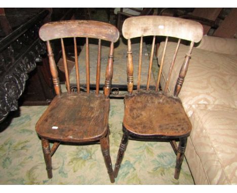 A pair of Windsor stained elm and beechwood stick back kitchen chairs raised on splay turned supports and stretchers