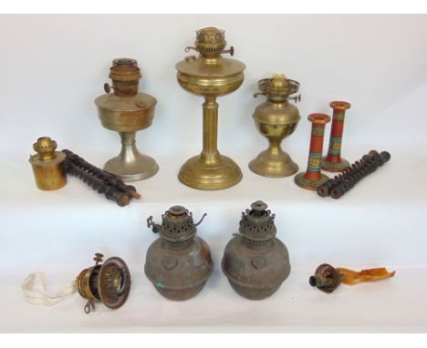 A box containing a collection of vintage oil lamps and other lighting