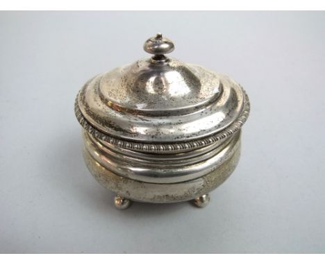 A silver tea caddy of oval form with domed lid with gadroon borders, London 1918, 6 oz 
