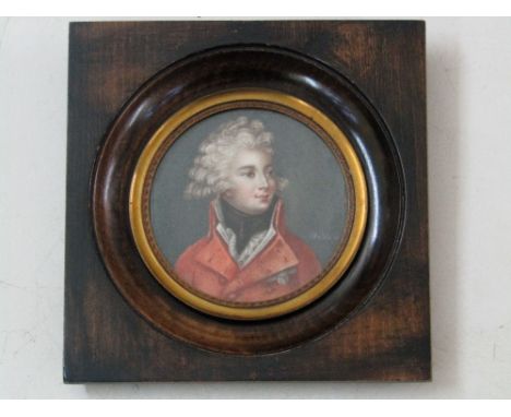 A miniature portrait of circular form showing a young gentleman in late 18th century style costume comprising a red coat and 