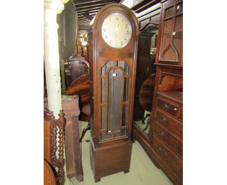 An early 20th century oak cased cigar shaped longcase clock with circular dial and glazed door with geometric mouldings