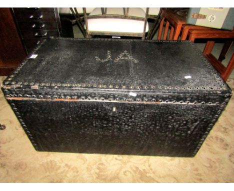 A mid 19th century oil skin covered travel trunk with brass stud borders and iron work handles, monogrammed JA, 81 cm wide