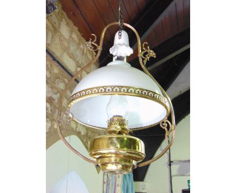 An early 20th century Belgian hanging ceiling light with brass frame, opaque white glass shade and smoke bell