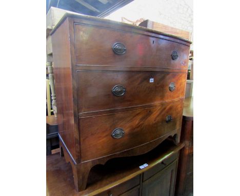 An early 19th century bow fronted bedroom chest of three long graduated drawers with shaped apron and bracket supports, 96 cm