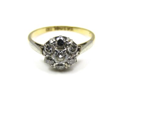 A diamond flower head ring in 18ct gold, central diamond 0.20cts approx, size K/L, 2g