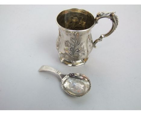 A Victorian embossed silver christening mug and an engraved Georgian silver caddy spoon 