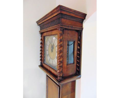 An 18th century walnut longcase clock, the quarter panelled full length door enclosing an oval lenticel, the hood with barley