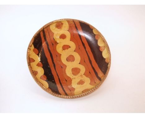 A Bernard Leach St Ives pottery slipware dish of circular form with slipware decoration in tones of dark brown, brick red and