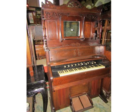 A late Victorian chapel harmonium "The Boston Organ", the case with simple carved detail, moulded outline and raised back inc