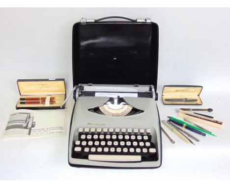 Cased Remington Envoy typewriter together with a collection of vintage pens